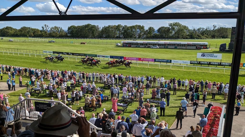 Image showing a view of a race in progress at Bath Racecourse.